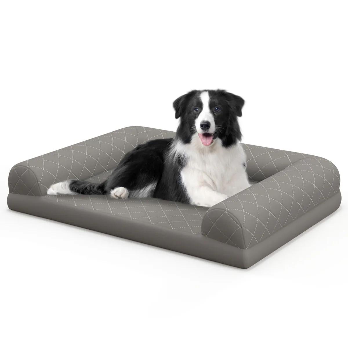 Grey quilted bolster dog bed on a white background with a border collie resting on it